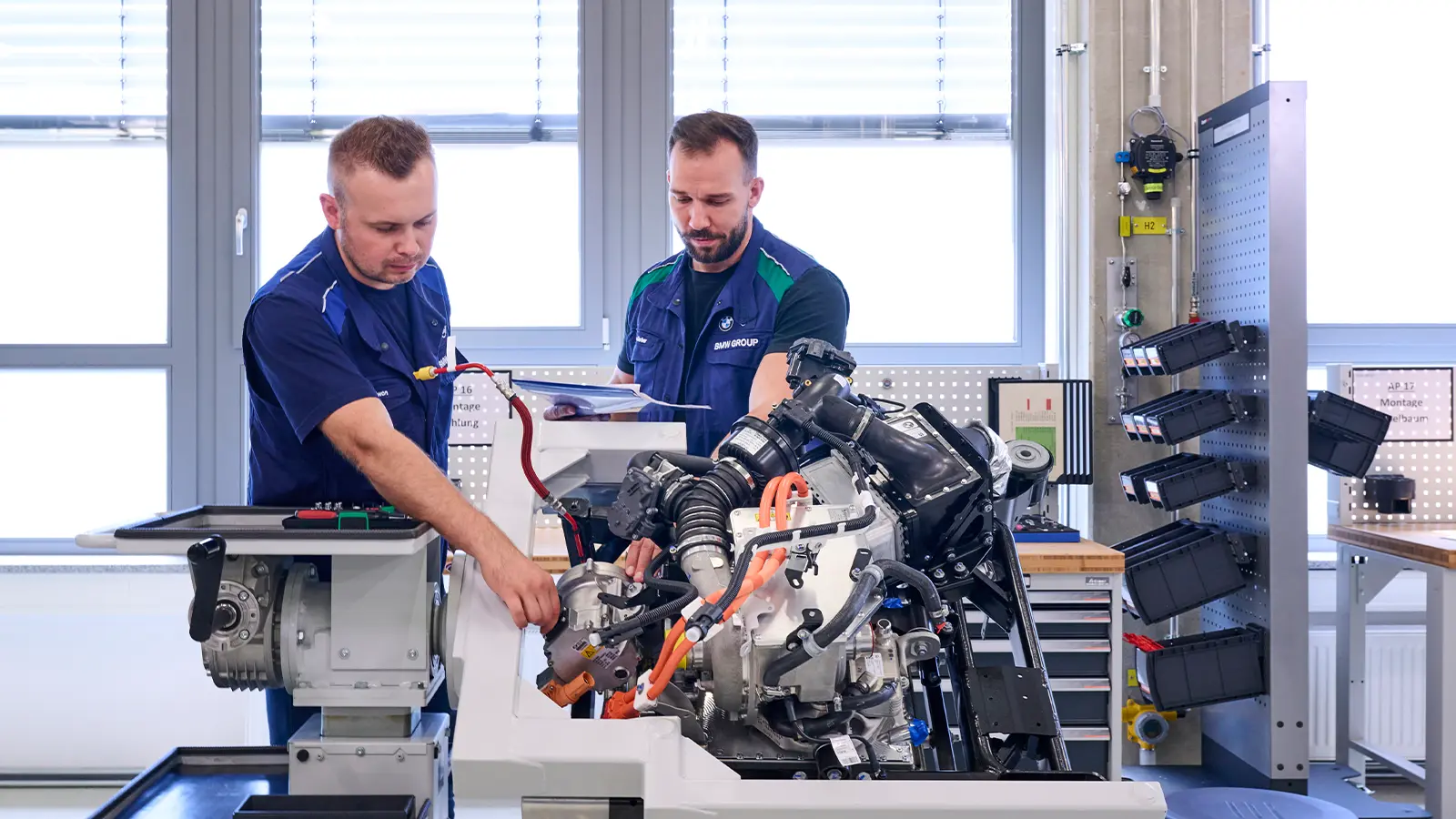 BMW mechanics look at engine